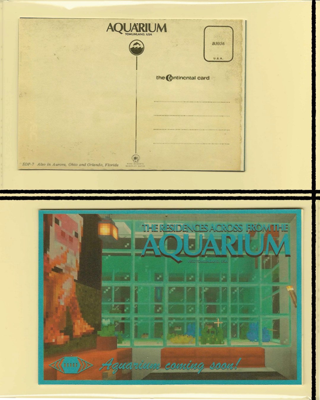 A mock vintage postcard for the residences across from the Aquarium in Tomlinland, showing a green glass Minecraft facade at night, captioned: Aquarium coming soon. The blank reverse of the card sits above it.